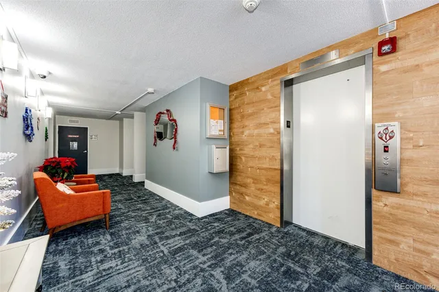 a view of a kitchen with a refrigerator and a stove top oven
