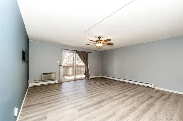 a view of balcony with wooden floor and fence