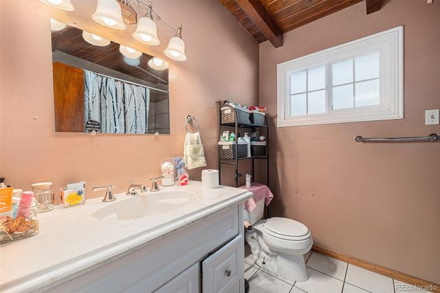 a bathroom with a sink a toilet and mirror