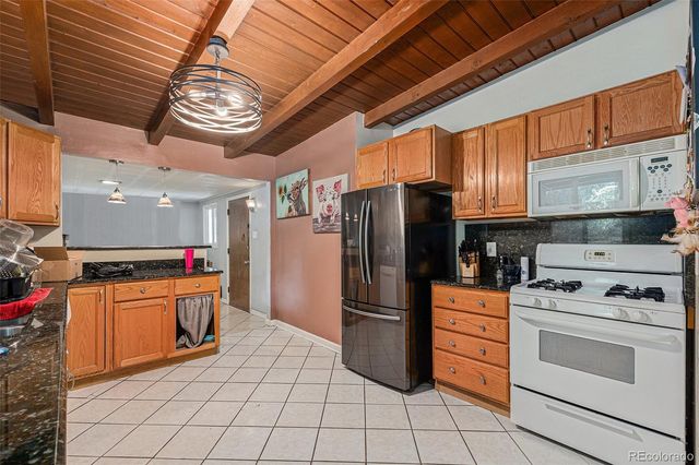 a kitchen with stainless steel appliances granite countertop a stove and a refrigerator