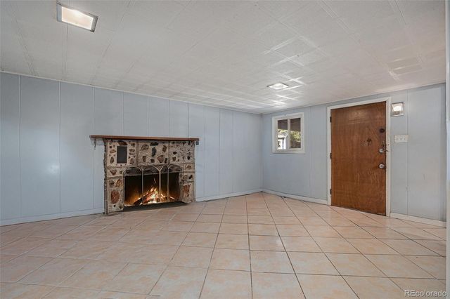 a view of an empty room with a fireplace
