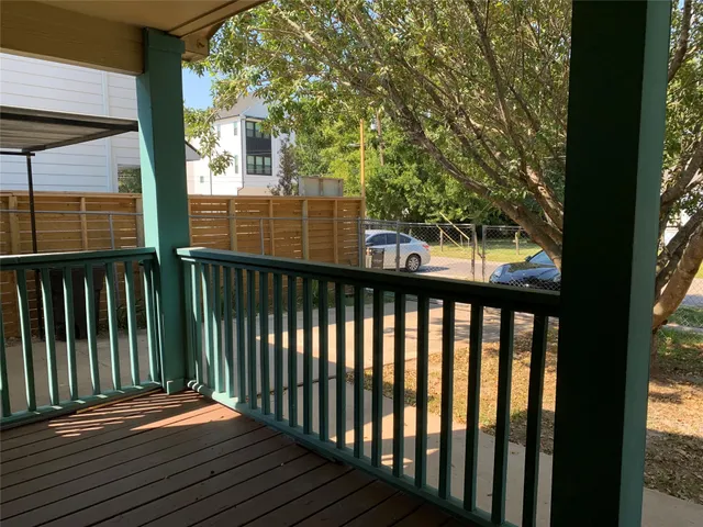 a balcony with view of trees in front of it