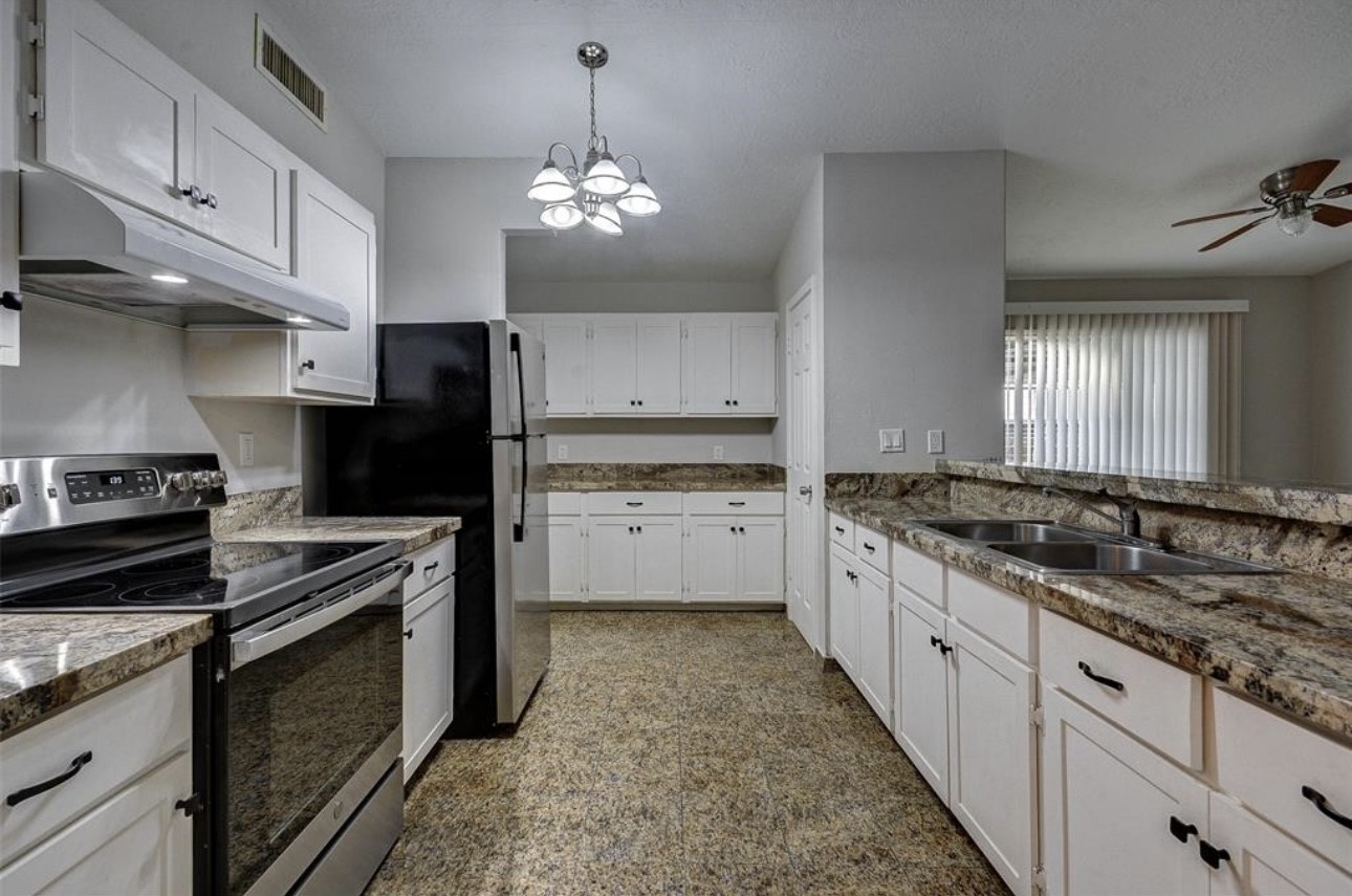 6723 Del Rio Street Houston, TX 77021 - Photo 5 of 29 a kitchen with granite countertop stainless steel appliances a stove oven and cabinets