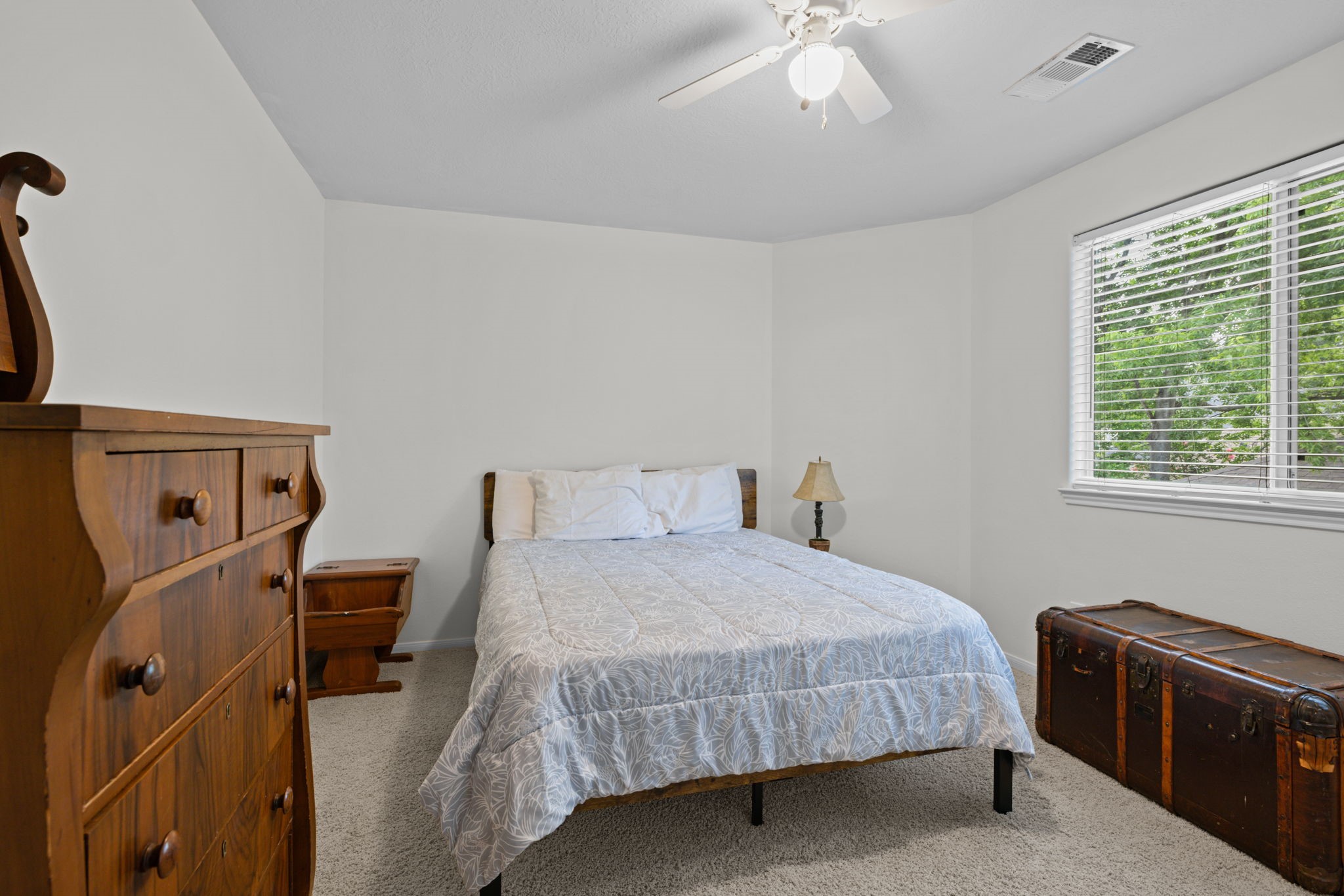 19114 Emory Trail Spring, TX 77388 - Photo 33 of 44 a bedroom with a bed and a chandelier