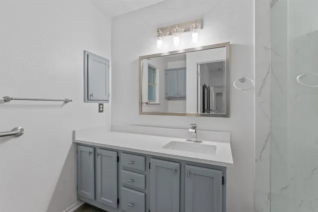 a bathroom with a double vanity sink and a mirror