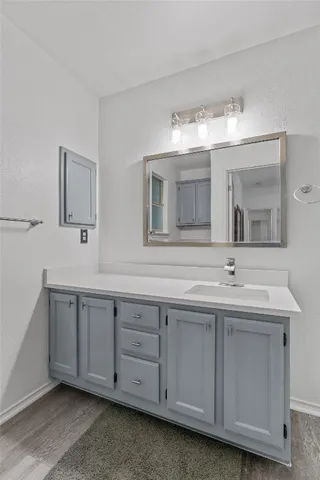 a bathroom with double sink and a mirror