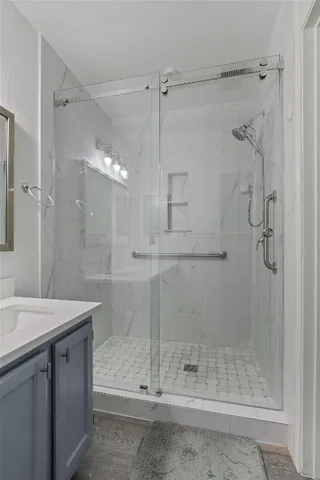 a bathroom with a shower and a sink