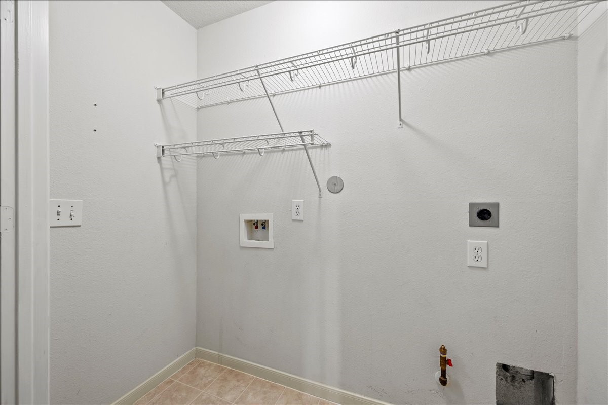 17535 Prospect Meadows Drive Houston, TX 77095 - Photo 28 of 39 The utility closet is thoughtfully designed featuring hanging rods to organize clothes, along with connections for a washer and options for either a gas or electric dryer. This functional space makes laundry tasks easier and keeps essentials within easy reach, helping to streamline your daily routine.