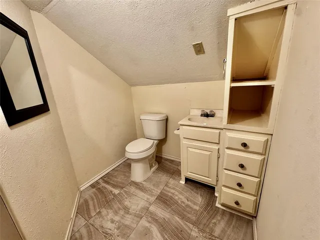 a bathroom with a toilet a sink and a mirror