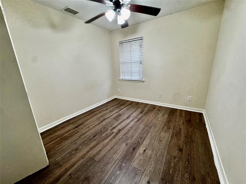 1706 Saddle Road Granbury, TX 76049 - Photo 14 of 29 wooden floor in an empty room with a window