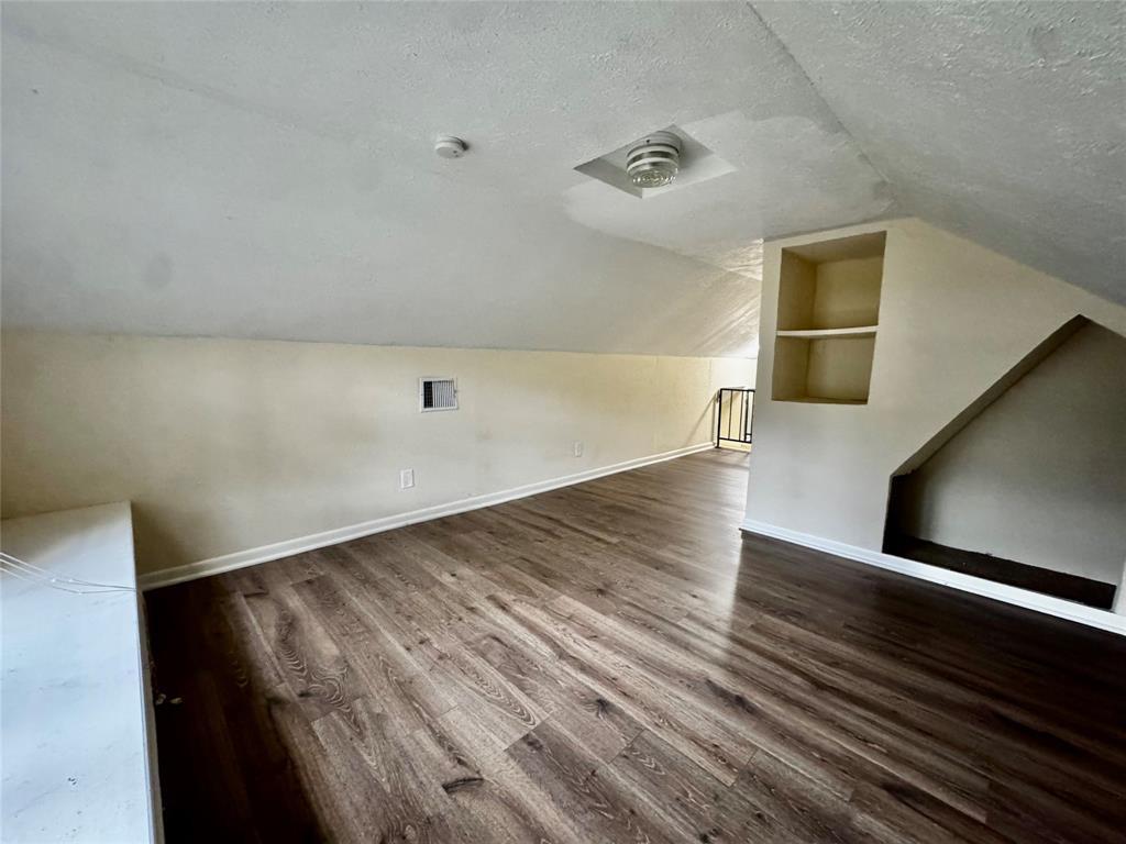 1706 Saddle Road Granbury, TX 76049 - Photo 21 of 29 a view of a hallway with wooden floor