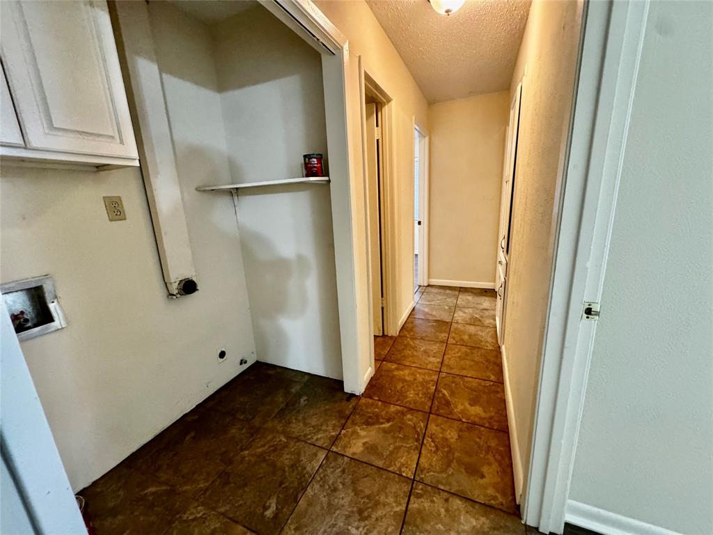 1706 Saddle Road Granbury, TX 76049 - Photo 22 of 29 a view of a hallway with wooden floor and cabinet