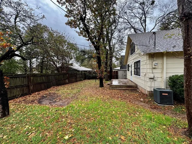 a view of a backyard with a tree