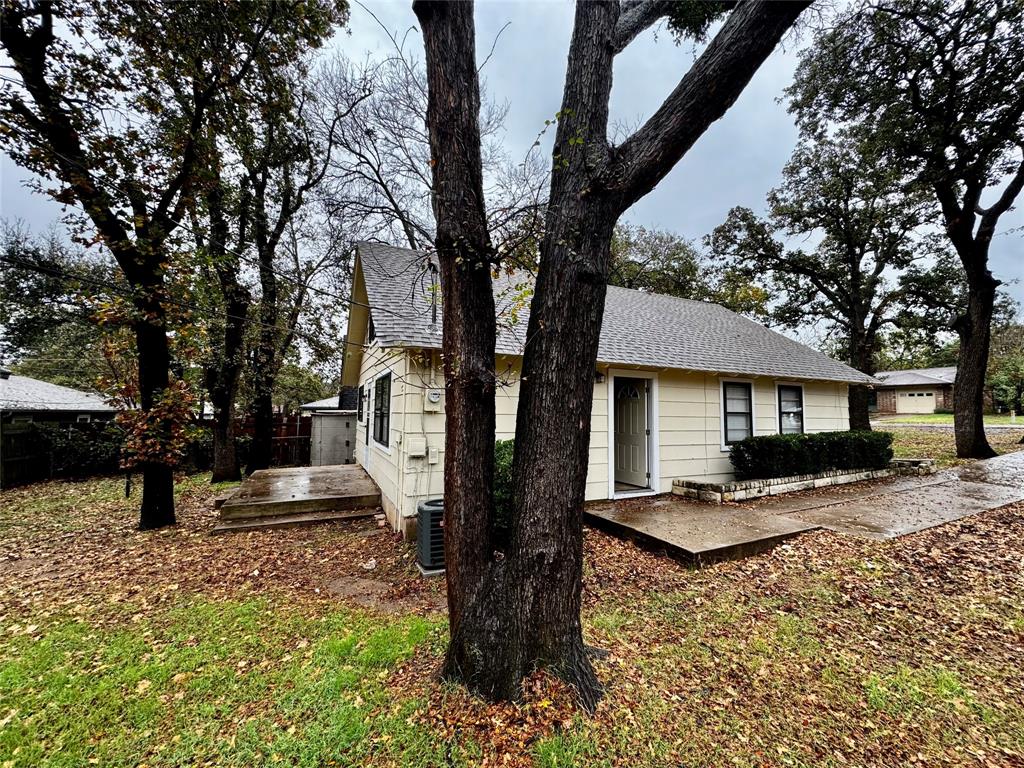 1706 Saddle Road Granbury, TX 76049 - Photo 26 of 29 a front view of a house with garden