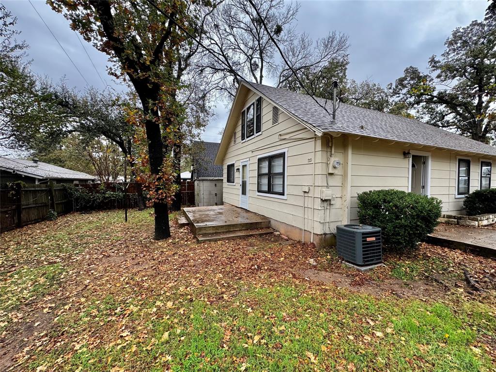 1706 Saddle Road Granbury, TX 76049 - Photo 28 of 29 a white house that has a tree in front of it