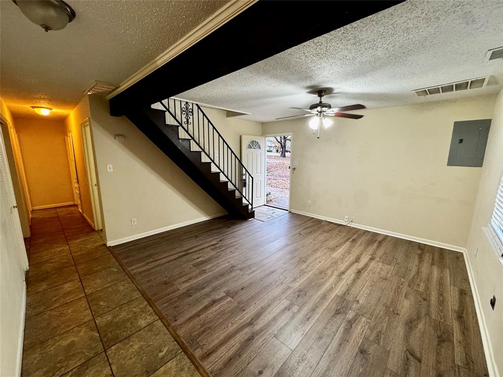 1706 Saddle Road Granbury, TX 76049 - Photo 4 of 29 a view of a hallway with wooden floor