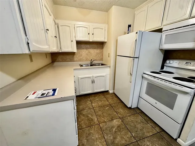 a kitchen with stainless steel appliances a refrigerator a stove a microwave and cabinets