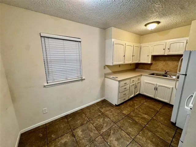 a kitchen with a cabinets and white appliances