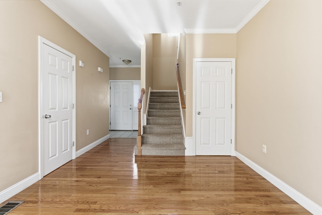 90 Rangeway Road, Unit 303 Billerica, MA 01862 - Photo 13 of 34 a view of a hallway with wooden floor and entryway