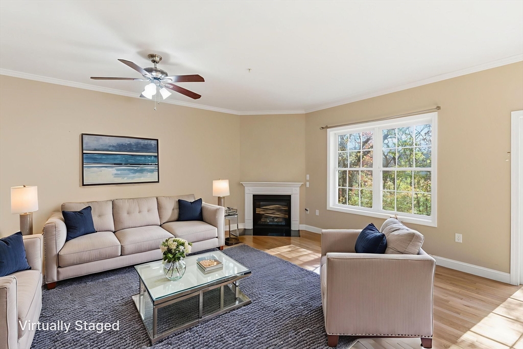 90 Rangeway Road, Unit 303 Billerica, MA 01862 - Photo 3 of 34 a living room with furniture a fireplace and a large window