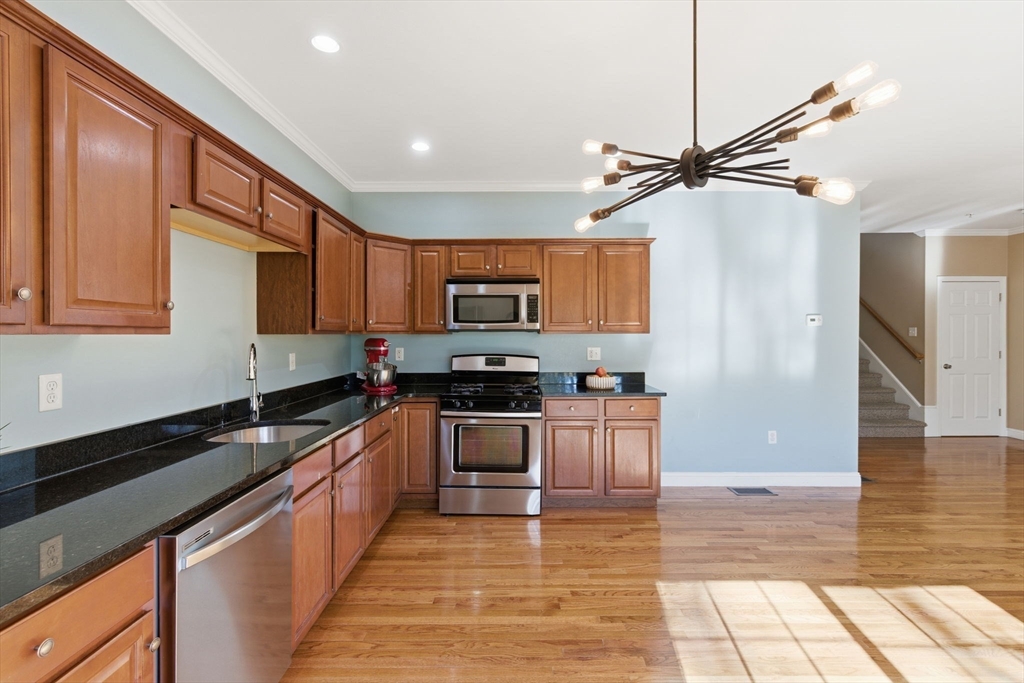 90 Rangeway Road, Unit 303 Billerica, MA 01862 - Photo 8 of 34 a kitchen with stainless steel appliances granite countertop a refrigerator a sink a stove top oven and a granite counter tops