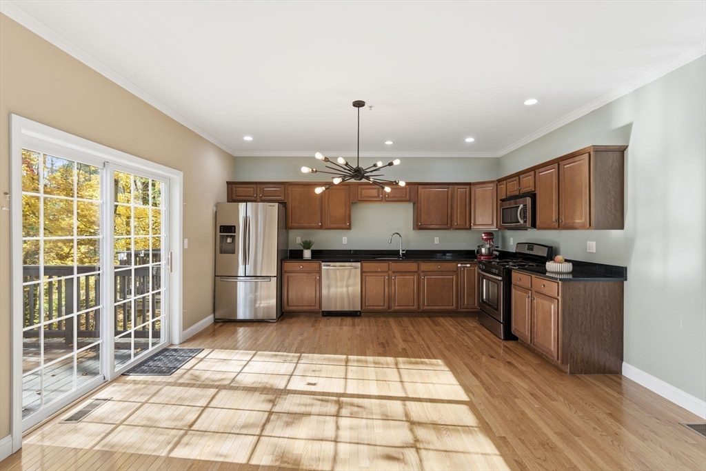 90 Rangeway Road, Unit 303 Billerica, MA 01862 - Photo 9 of 34 a large kitchen with granite countertop a large counter top stainless steel appliances and cabinets