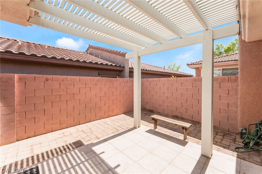10481 Riverside Park Avenue Las Vegas, NV 89135 - Photo 32 of 51 Fenced backyard featuring a patio area and a pergola