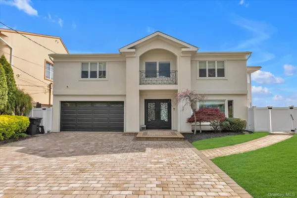a front view of a house with a garden and yard