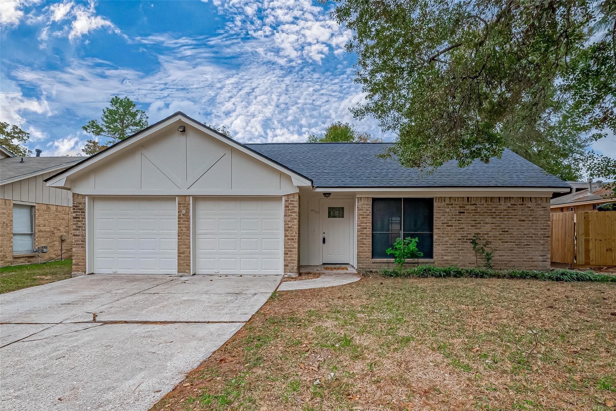 4907 Fox Hollow Boulevard Spring, TX 77389 - Photo 2 of 12 a front view of a house with a yard and garage