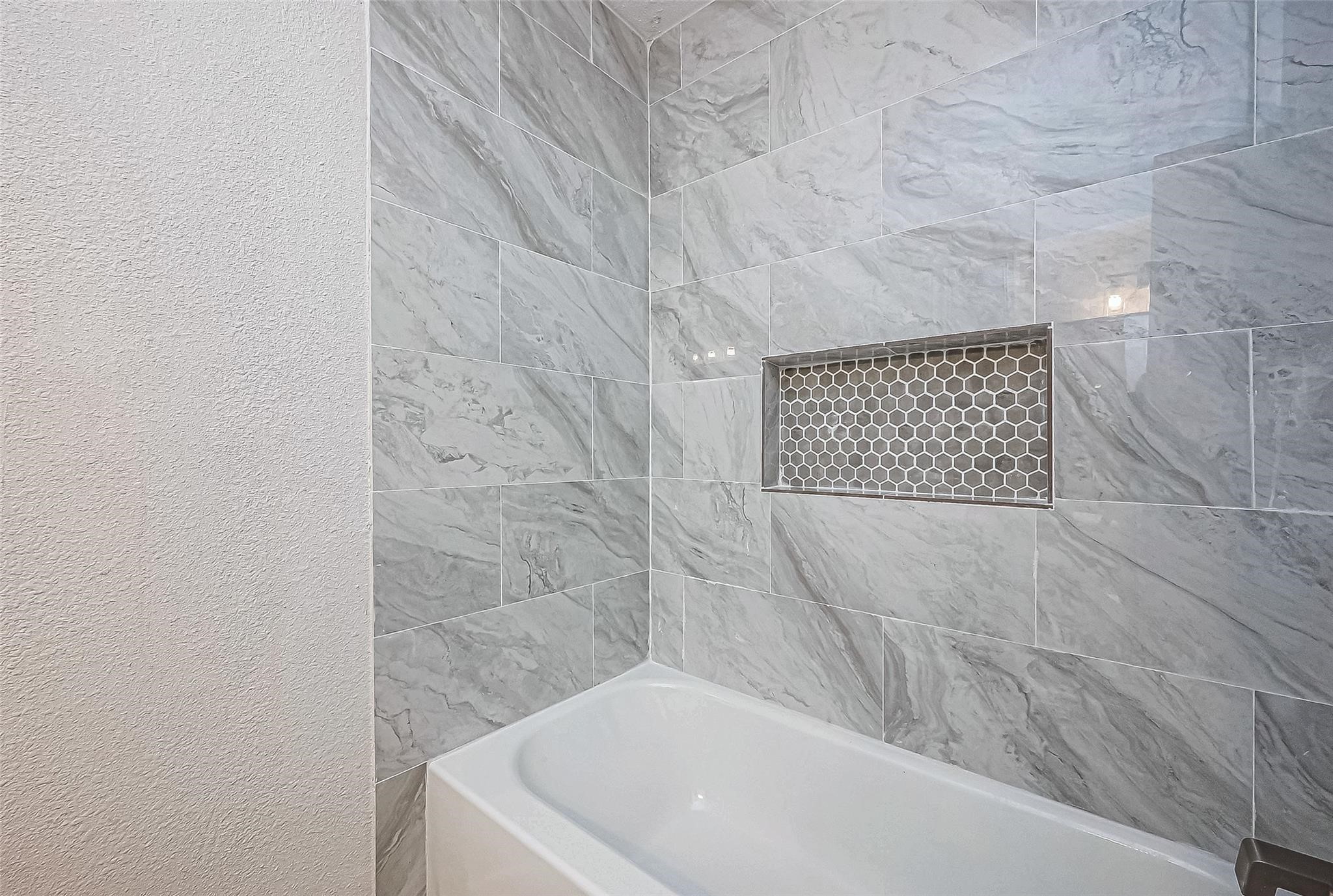 4907 Fox Hollow Boulevard Spring, TX 77389 - Photo 9 of 12 a bathroom with a bathtub