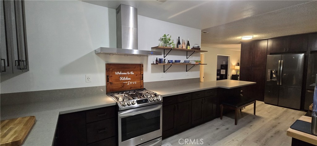 6830 Astoria Drive Riverside, CA 92503 - Photo 11 of 23 a kitchen with stainless steel appliances a stove a sink and a refrigerator