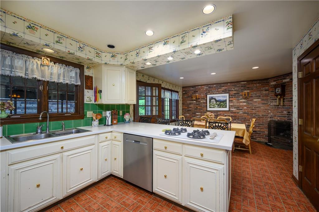 24 Myrtle Hill Road Sewickley, PA 15143 - Photo 7 of 21 Kitchen with view into breakfast nook. Exposed brick wall. Fireplace.