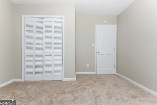 an empty room with closet area