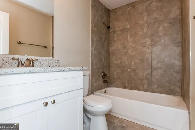a bathroom with a sink a toilet and bathtub