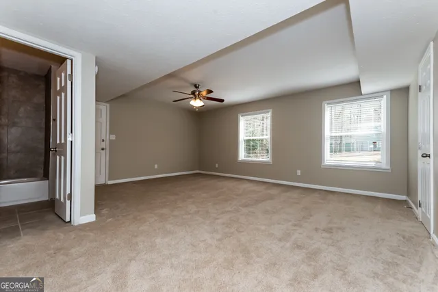 an empty room with windows and closet