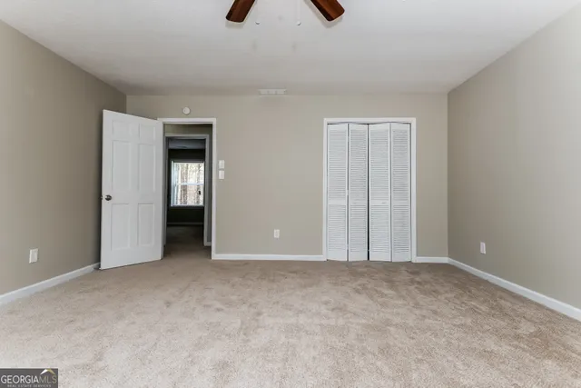 a view of an empty room with a bathroom