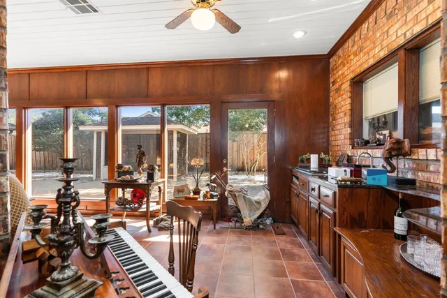 a living room with fireplace furniture and a large window
