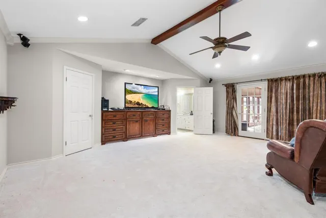 a view of a bedroom with wooden floor
