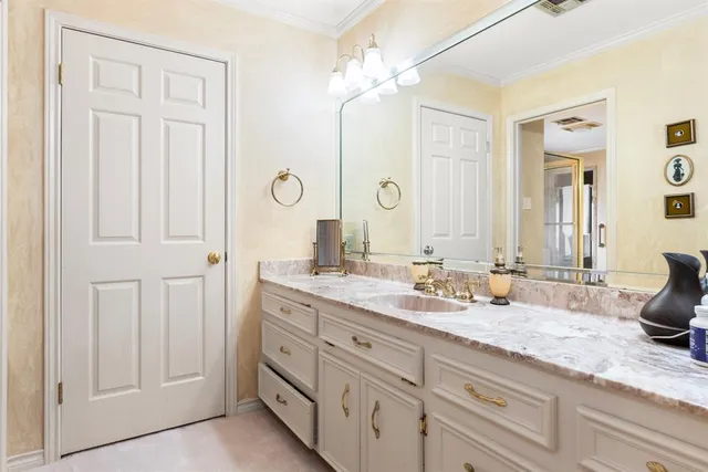 a bathroom with a double vanity sink toilet and shower