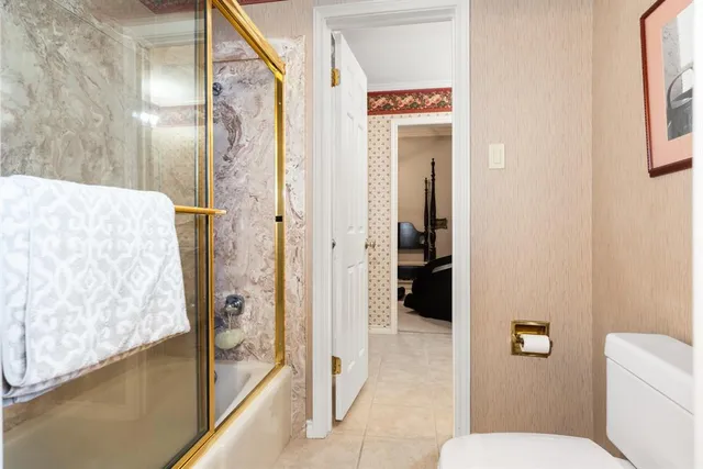 a living room with furniture gym equipment and a chandelier