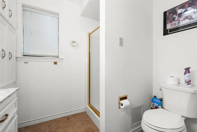 a view of a yard with plants and a patio