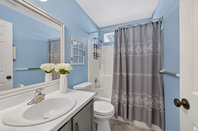 2190 West 1450th Street North Layton, UT 84041 - Photo 4 of 11 Bathroom featuring a single vanity with a white countertop and undermount sink, brushed nickel faucet, and a large framed mirror
