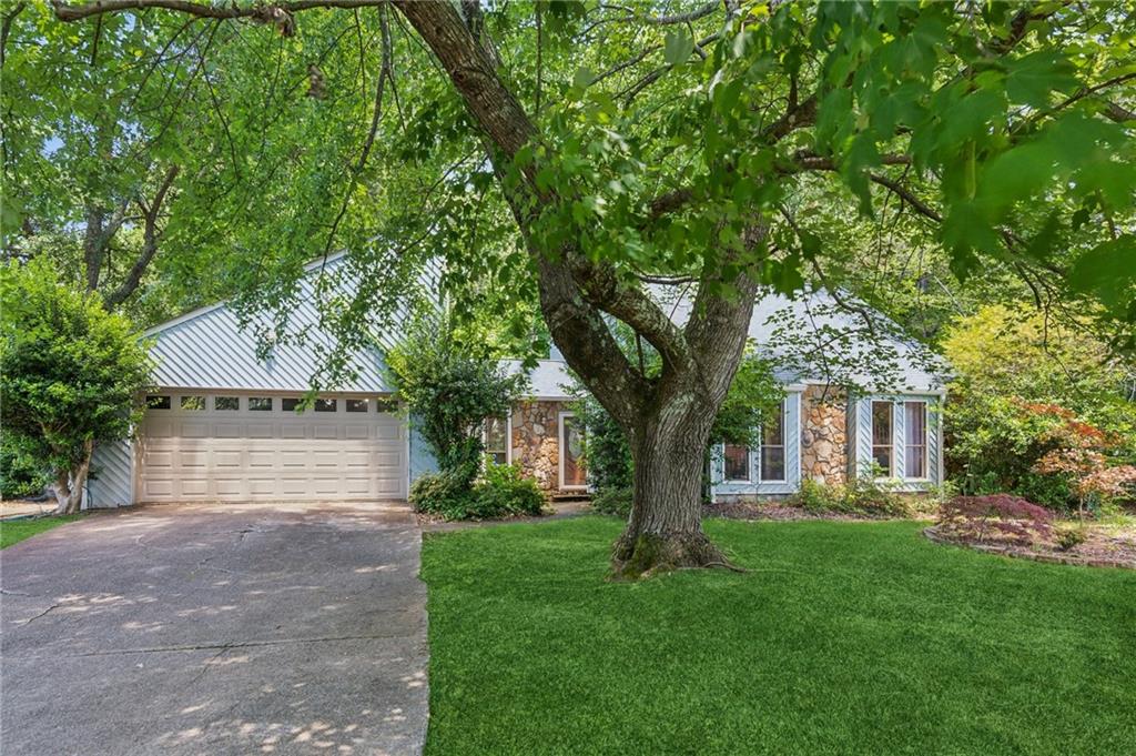 a front view of house with yard and green space