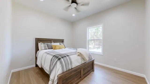 a bedroom with a bed and window