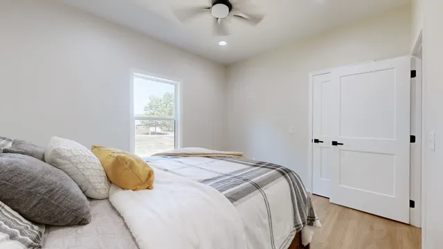 a bedroom with a bed and a window
