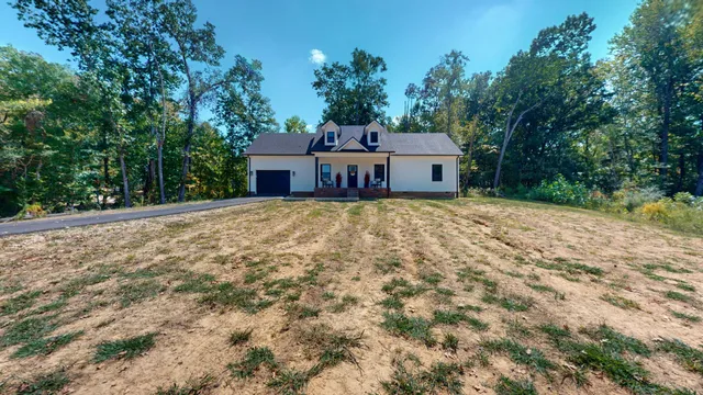 a house that has a tree in front of it