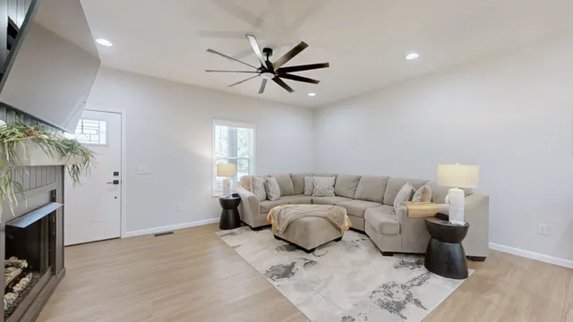 a living room with furniture and a fireplace