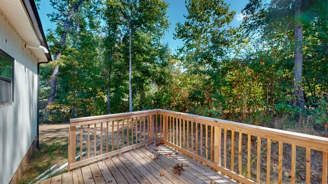 a view of balcony with deck and trees