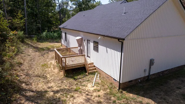 a view of a house with backyard and deck