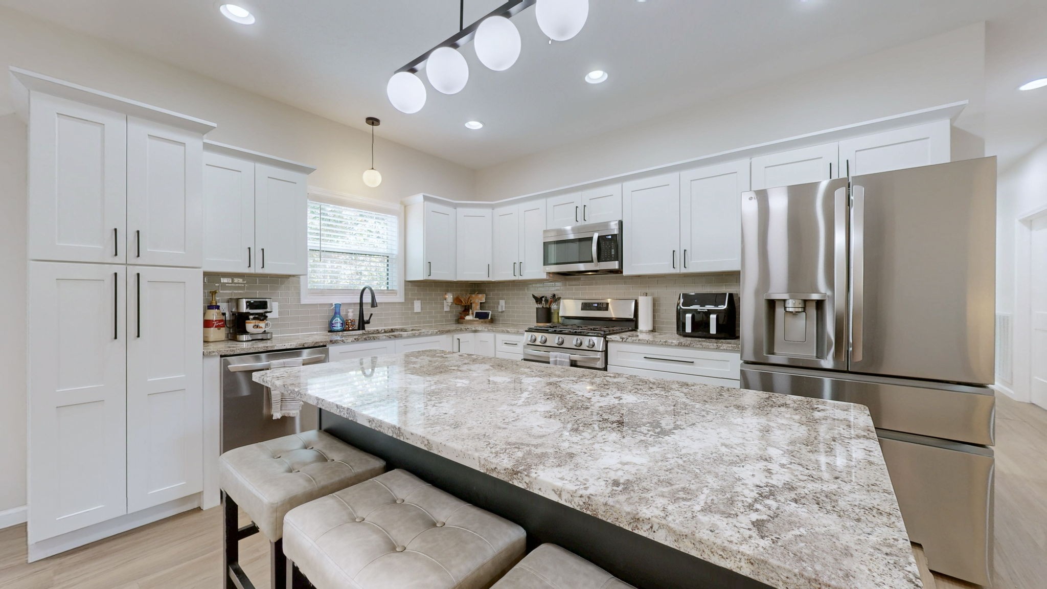 140 Jackson Forest Road Paris, TN 38242 - Photo 6 of 33 a kitchen with a refrigerator a stove a sink a dining table and chairs